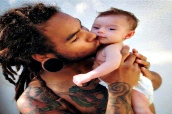 Dad kissing baby.