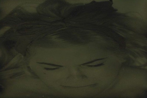 Woman eyes closed, head down