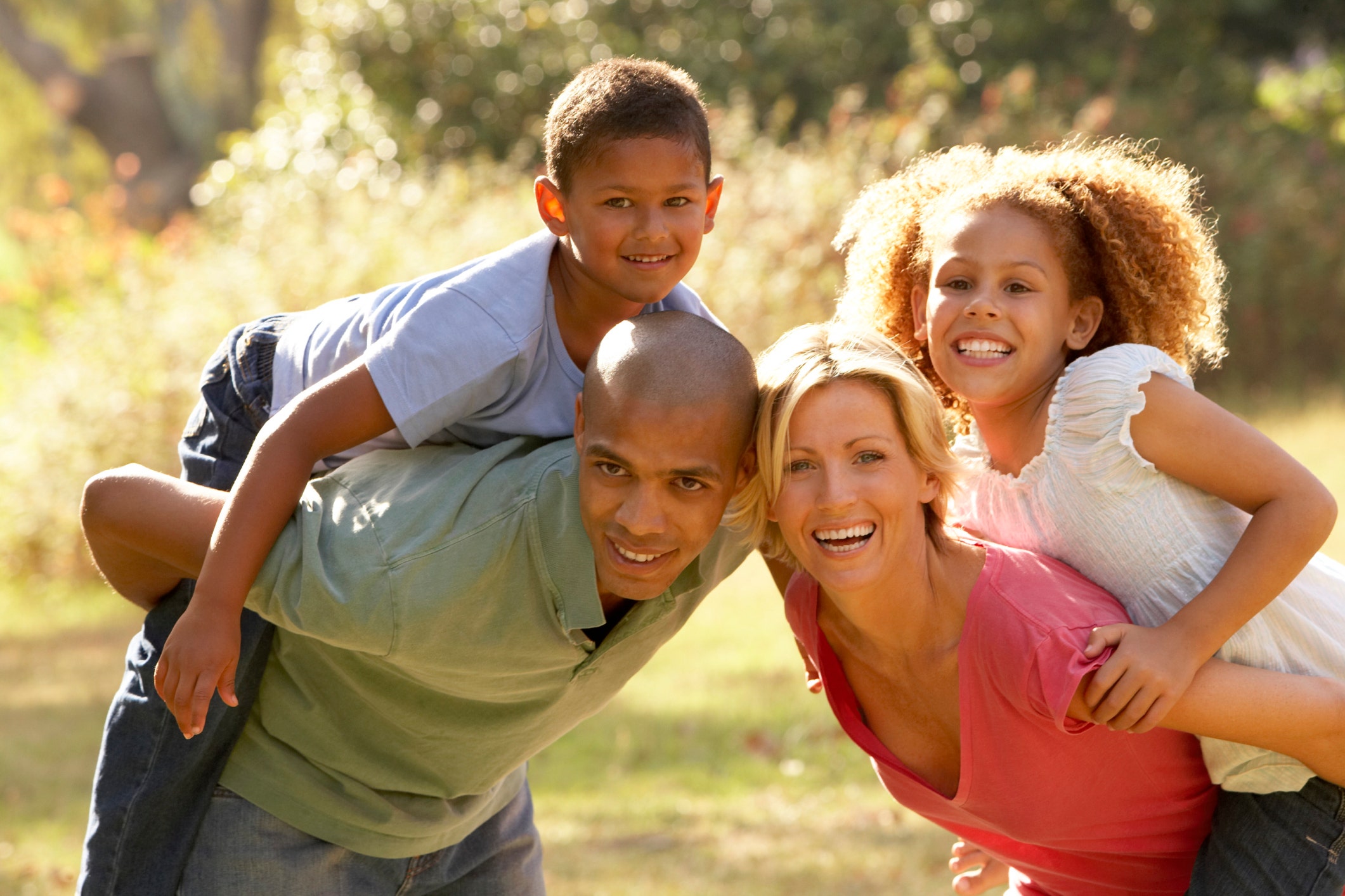 parents giving kids piggyback ride