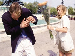 A woman confronts a man with flowers