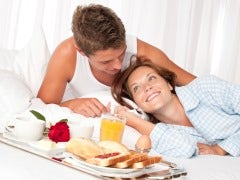Couple having breakfast in bed
