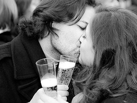 a couple kissing with champagne