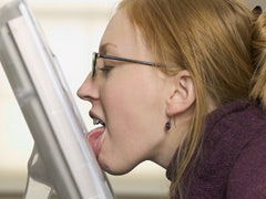 woman licking computer