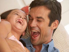 father and daughter laughing
