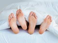 Feet peek out from under bed covers