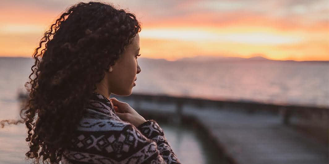 woman staring off into sunset