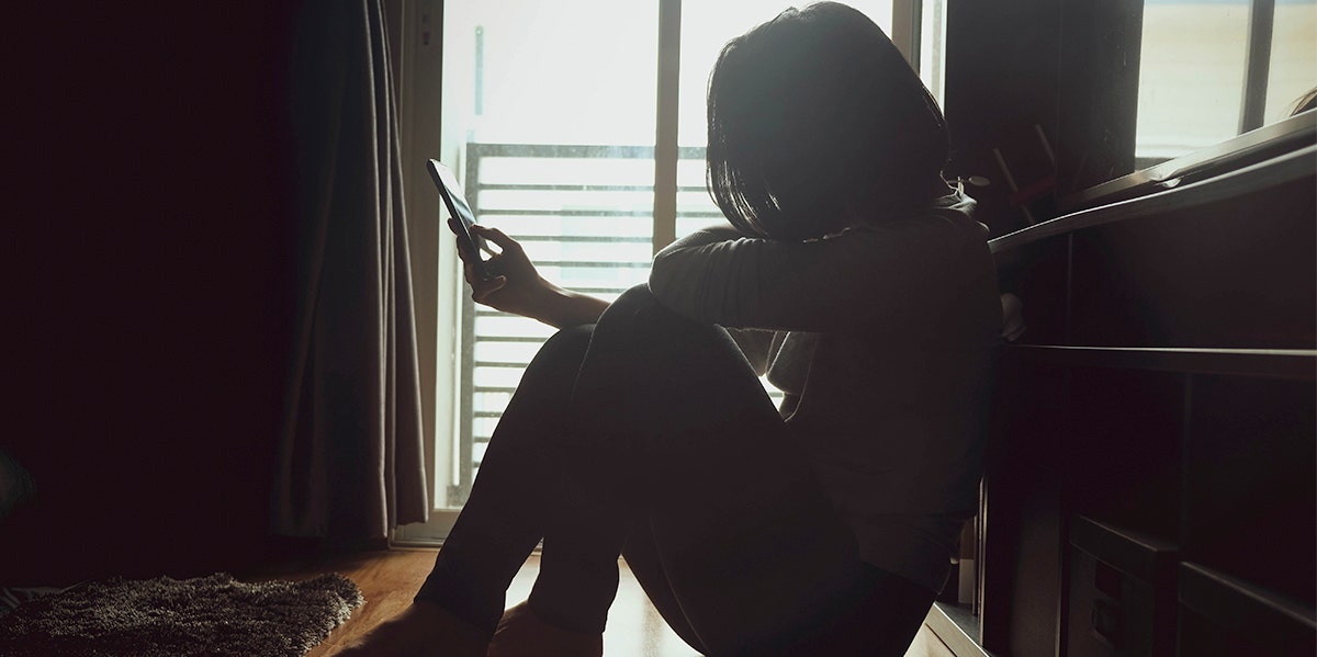 woman sitting in the dark