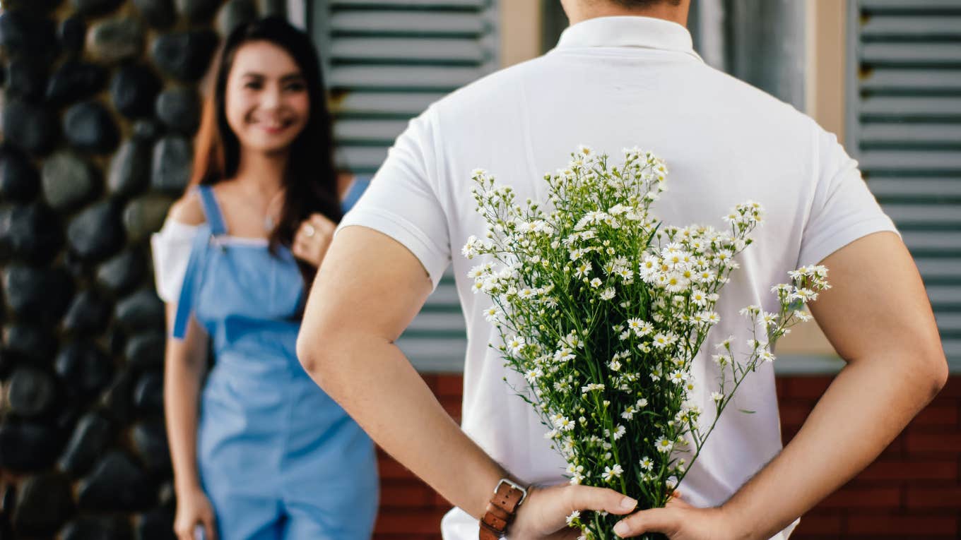 Man giving woman flowers 