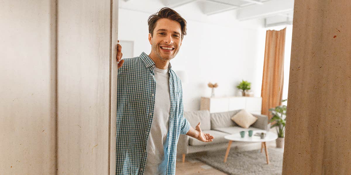 man holding the door to this house