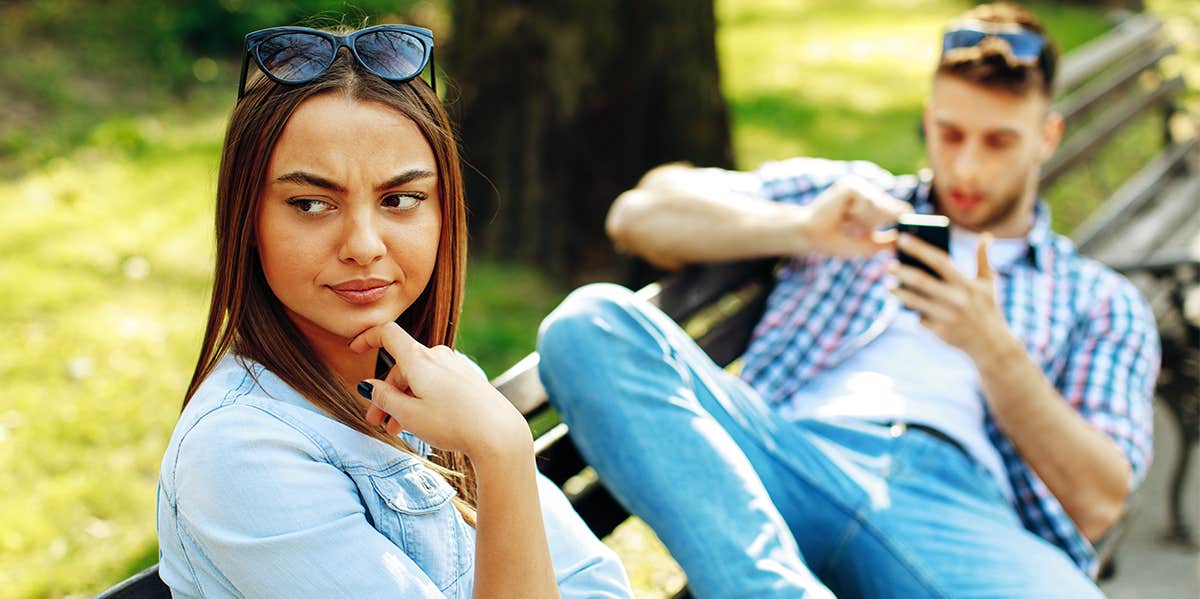 man ignoring woman on date