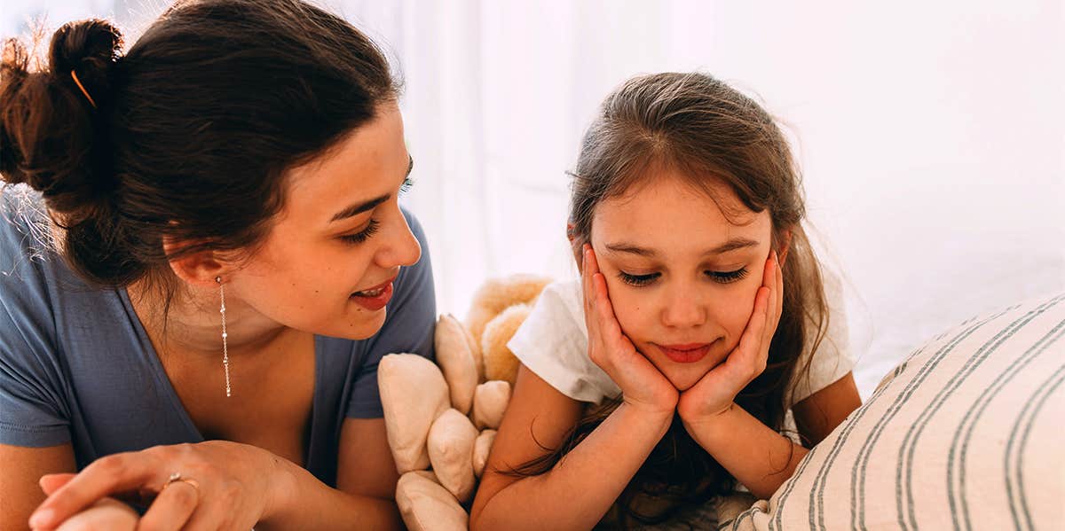 mom talking to young daughter