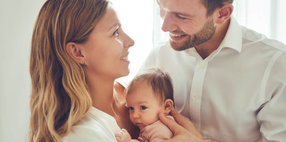 parents holding baby