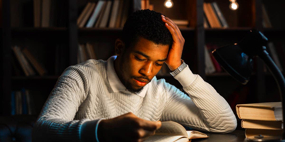 man reading in library