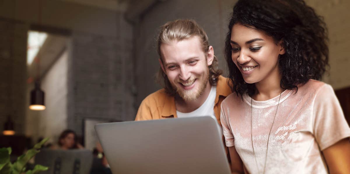 couples looking at labtop