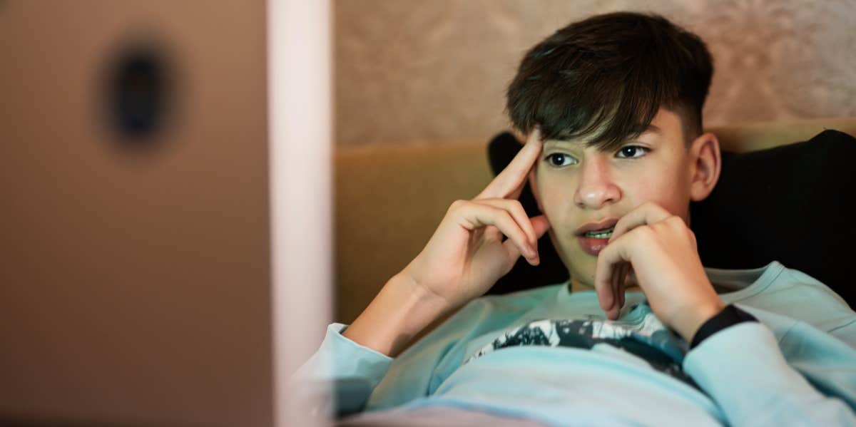 Signs You’re Raising A Boy Who'll Be A Total Relationship Failure teen boy looking at screen