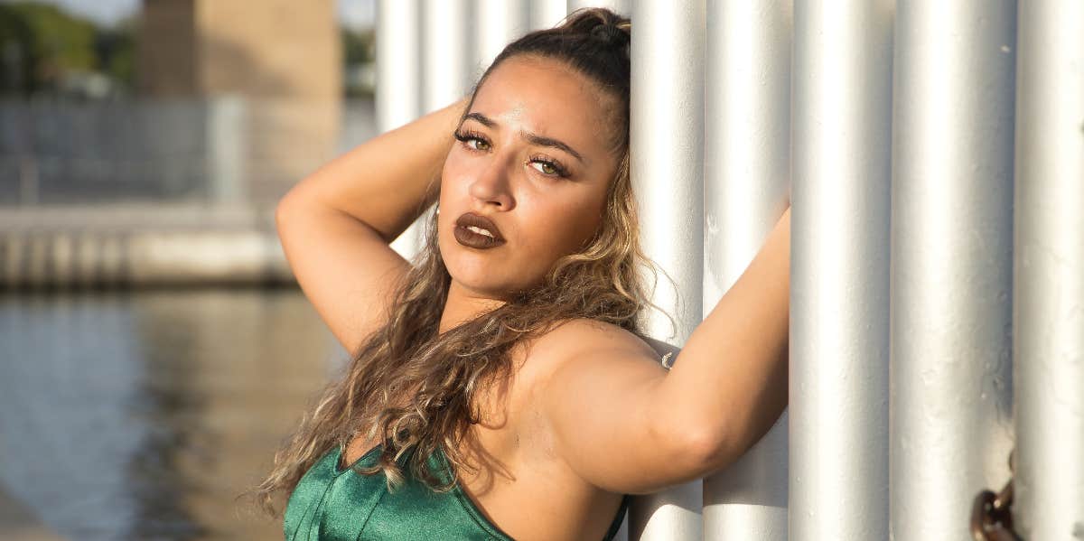 latina woman leaning against beams