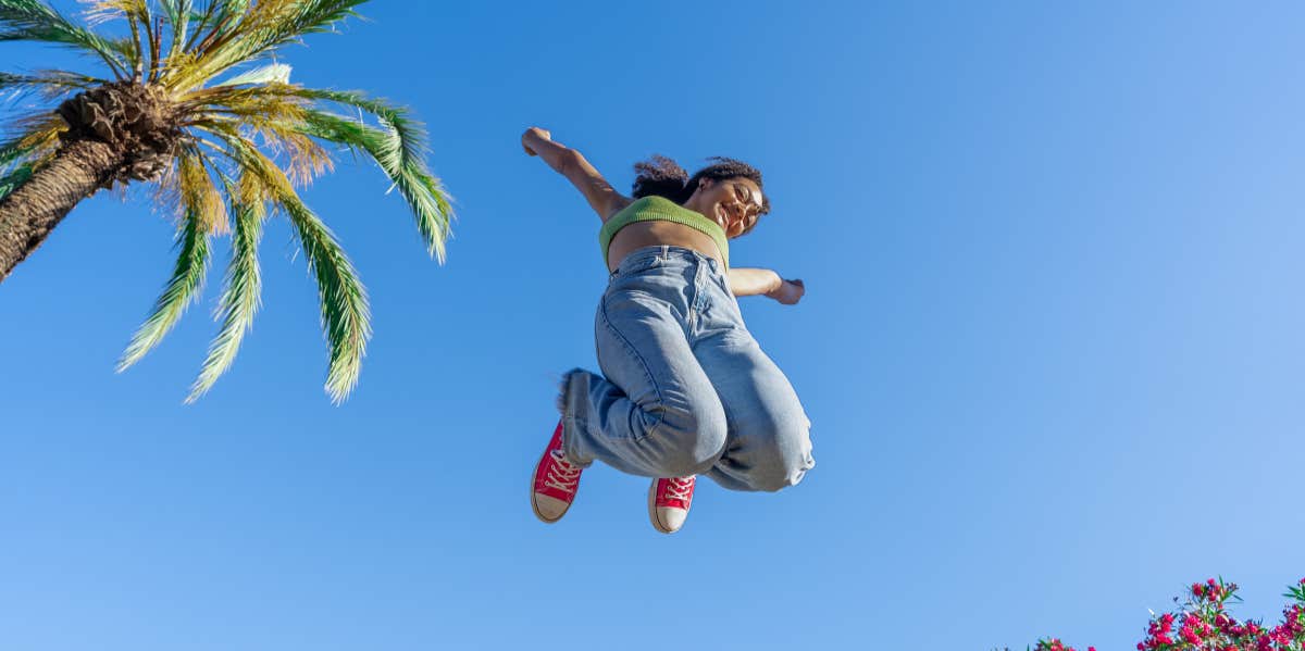10 Things To Do To Learn How To Be Happy ALONE woman jumping in the air