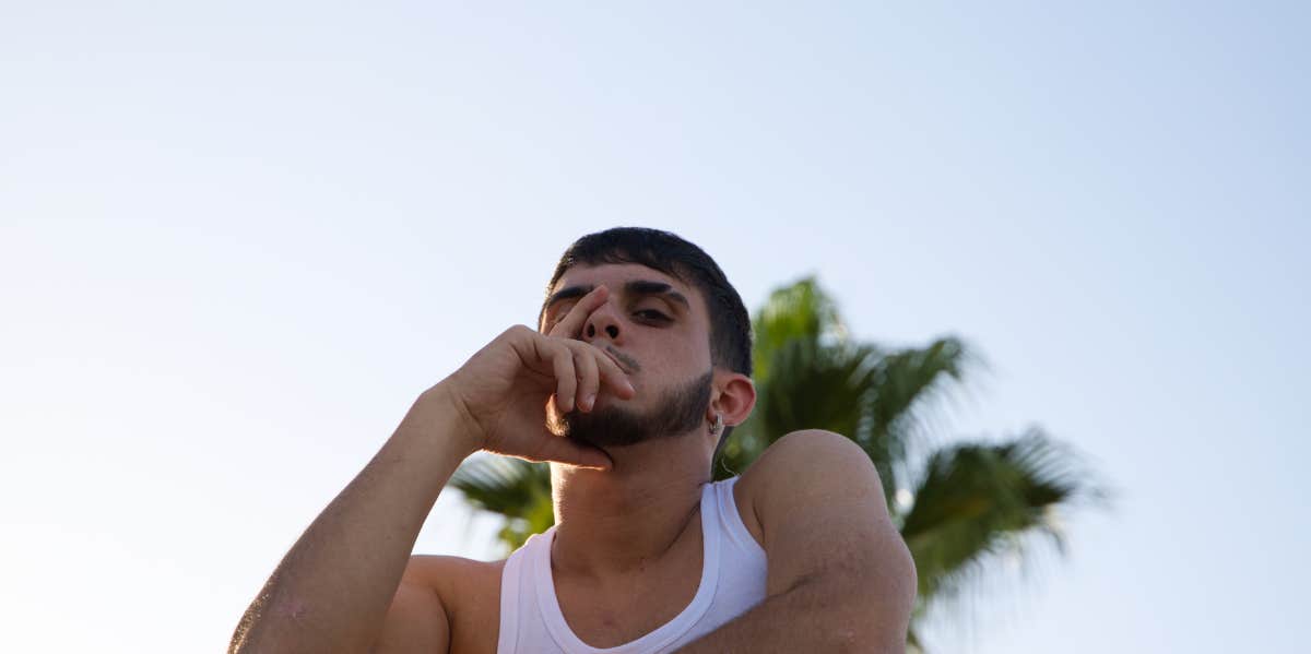 man in front of palm tree