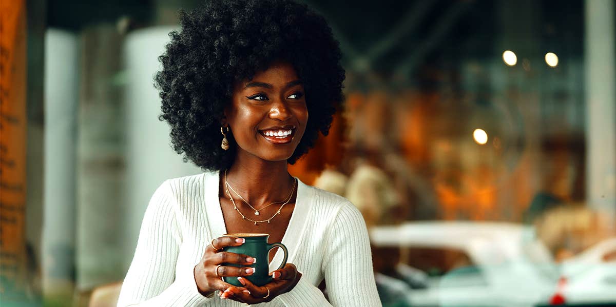 attractive smiling woman holding coffee