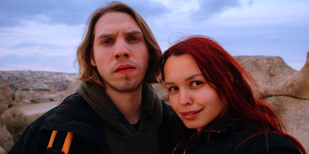 man and woman taking selfie in canyon