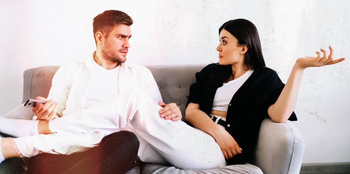 couple having disagreement on couch