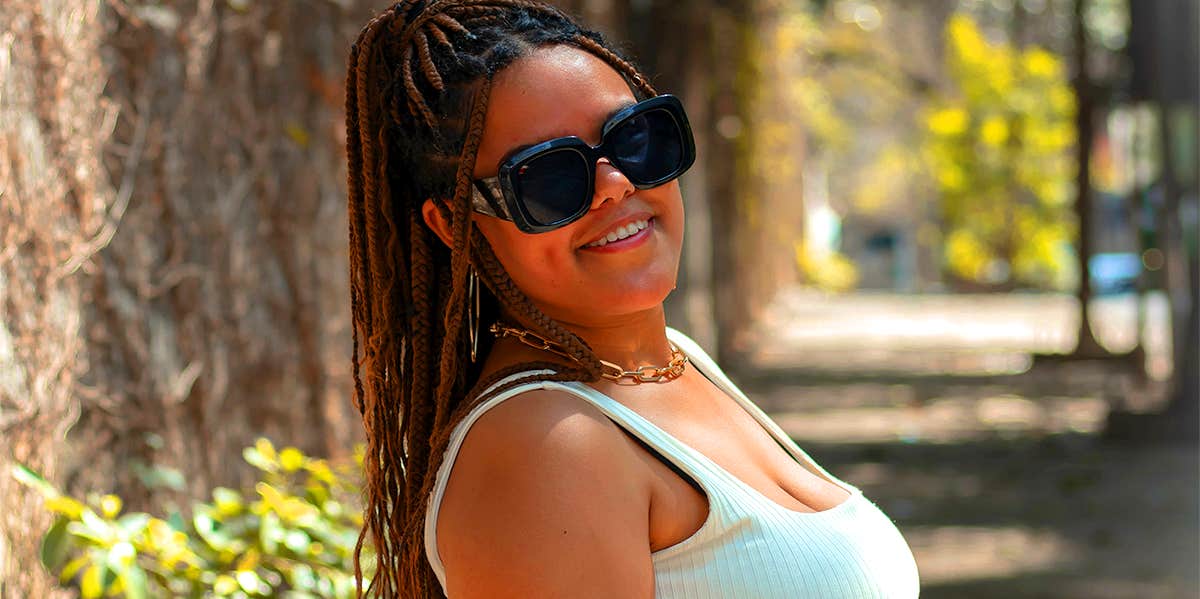 woman wearing sunglasses posing outside