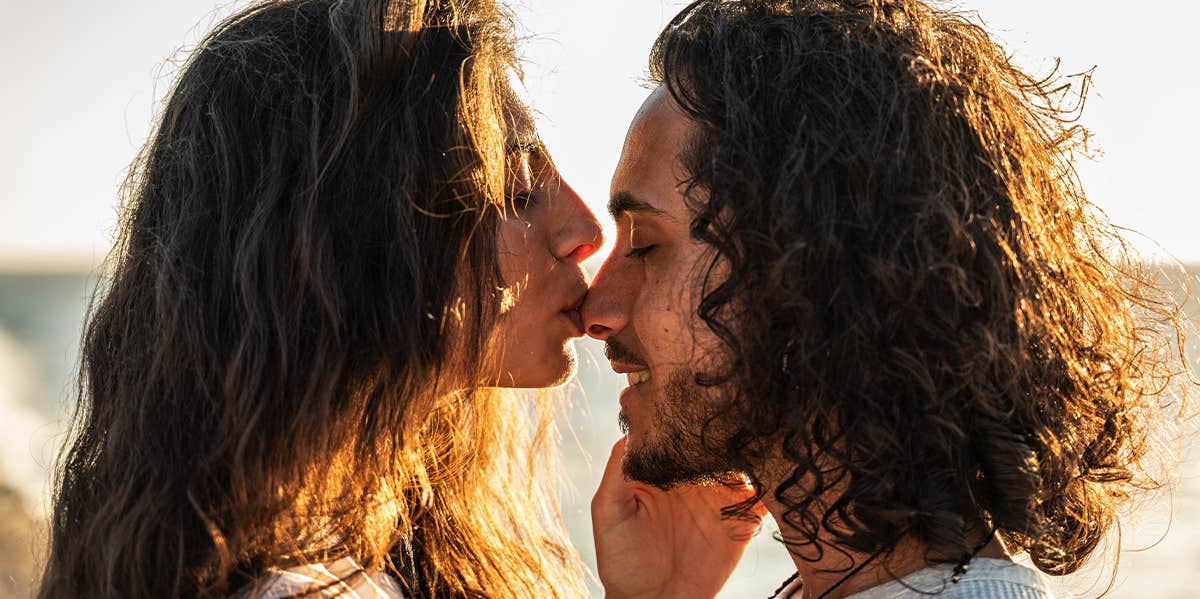 woman kissing man's face