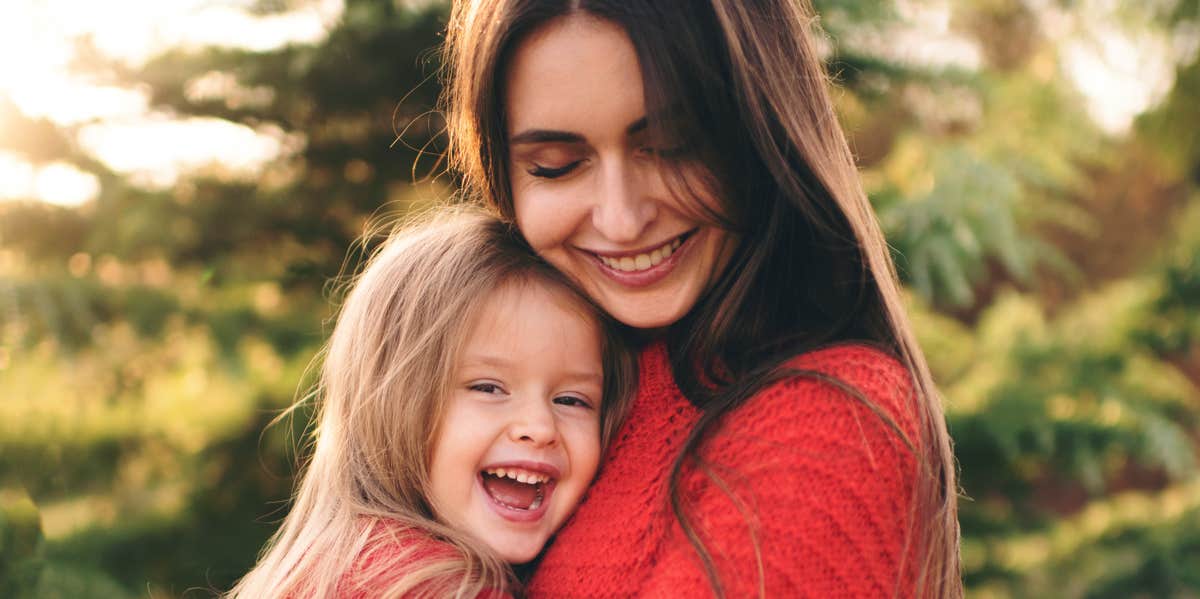 mother holding daughter