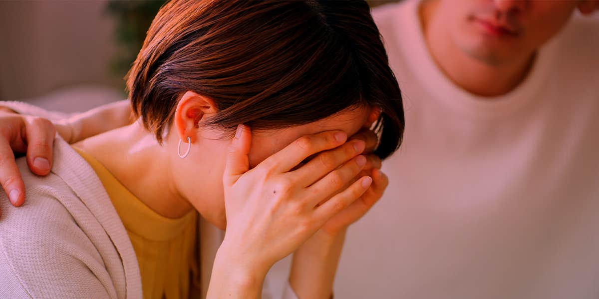 upset woman with husband comforting her