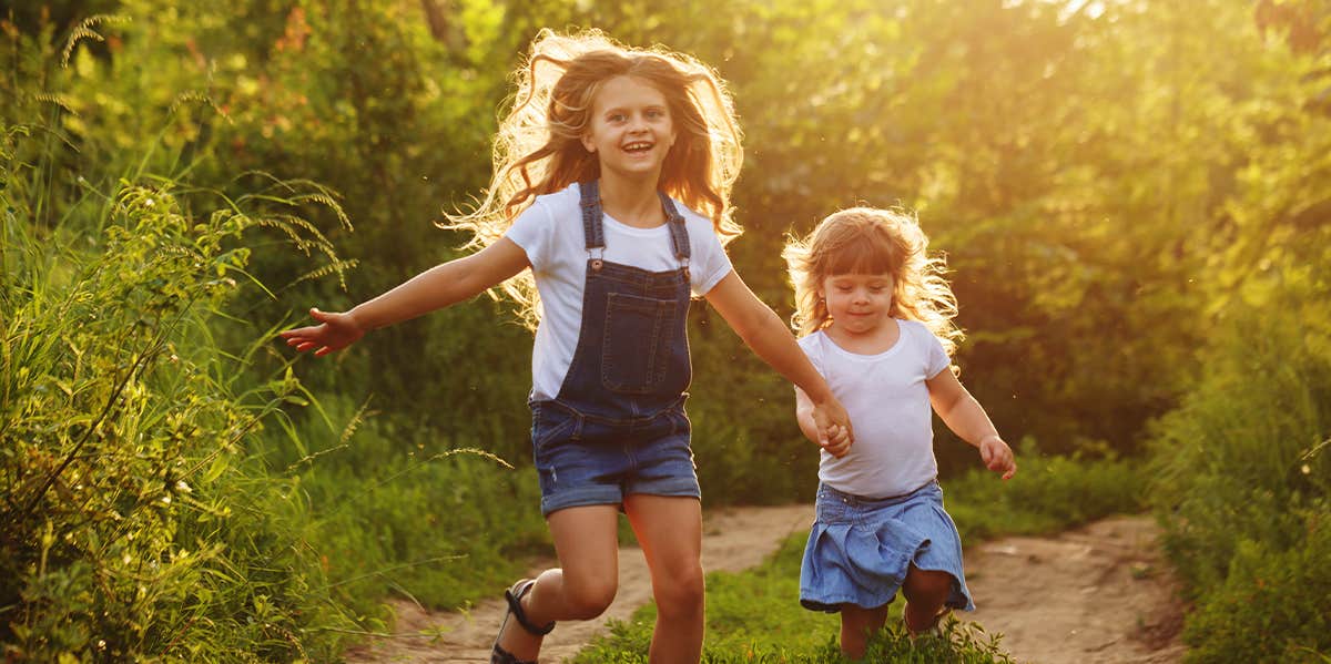 2 little girls frolicking in field