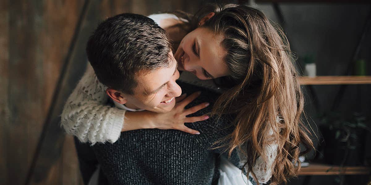 woman hugging boyfriend from behind