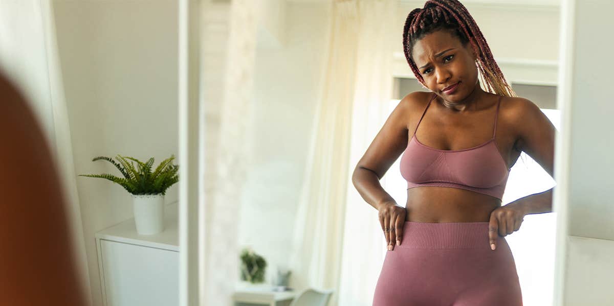 10 Weight Loss Tips That Actually Make You Gain Weight woman looking in the mirror