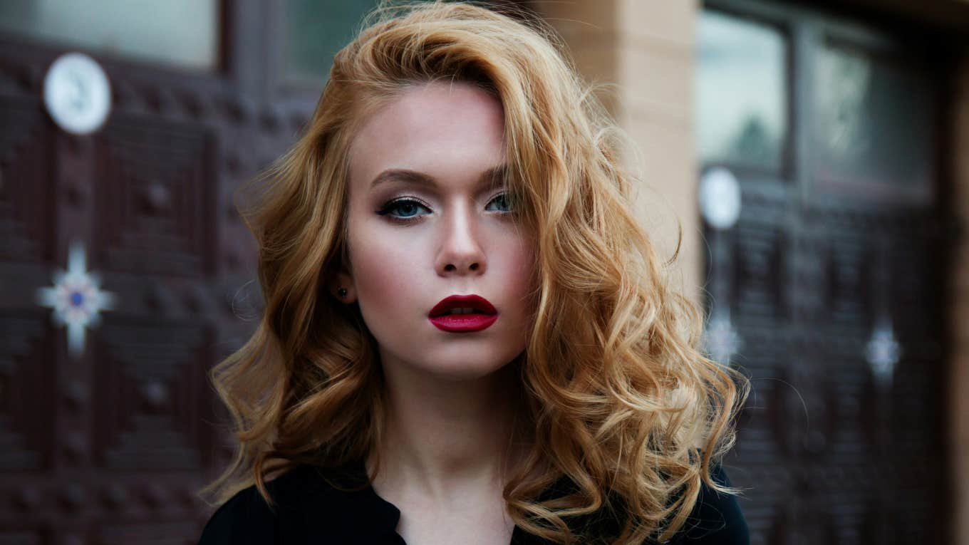 a woman with red lipstick and red hair 