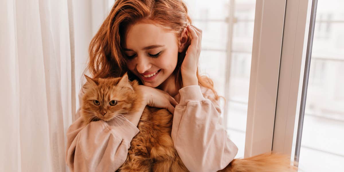 woman holding cat