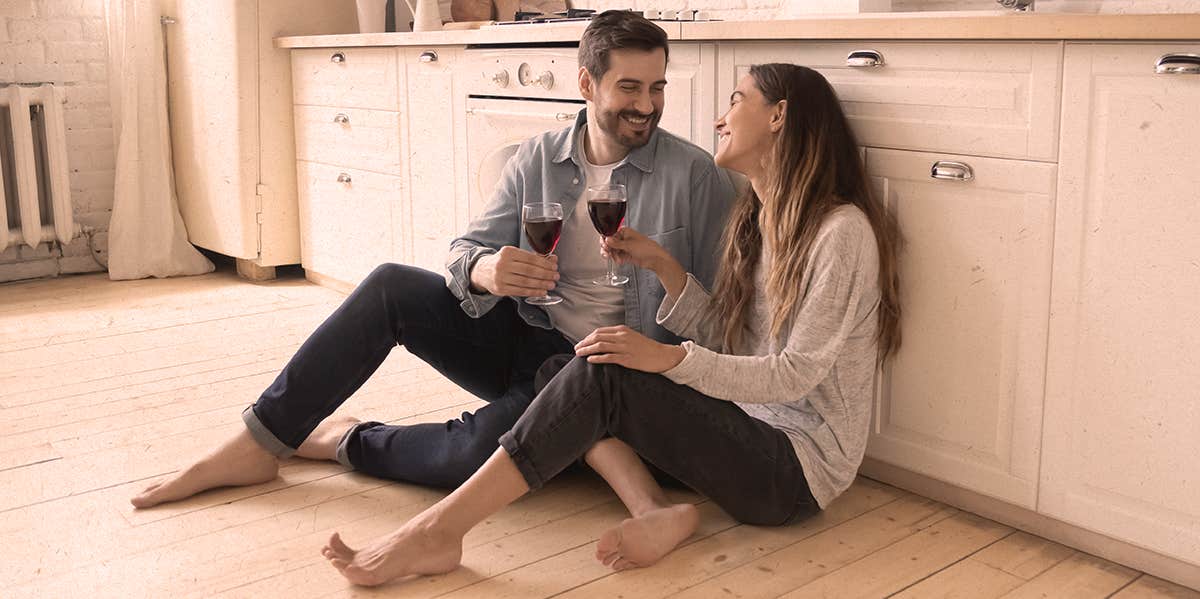 11 Ways To Develop Strong Emotional Intimacy So Your Marriage Never Ends couple sitting on kitchen floor, drinking