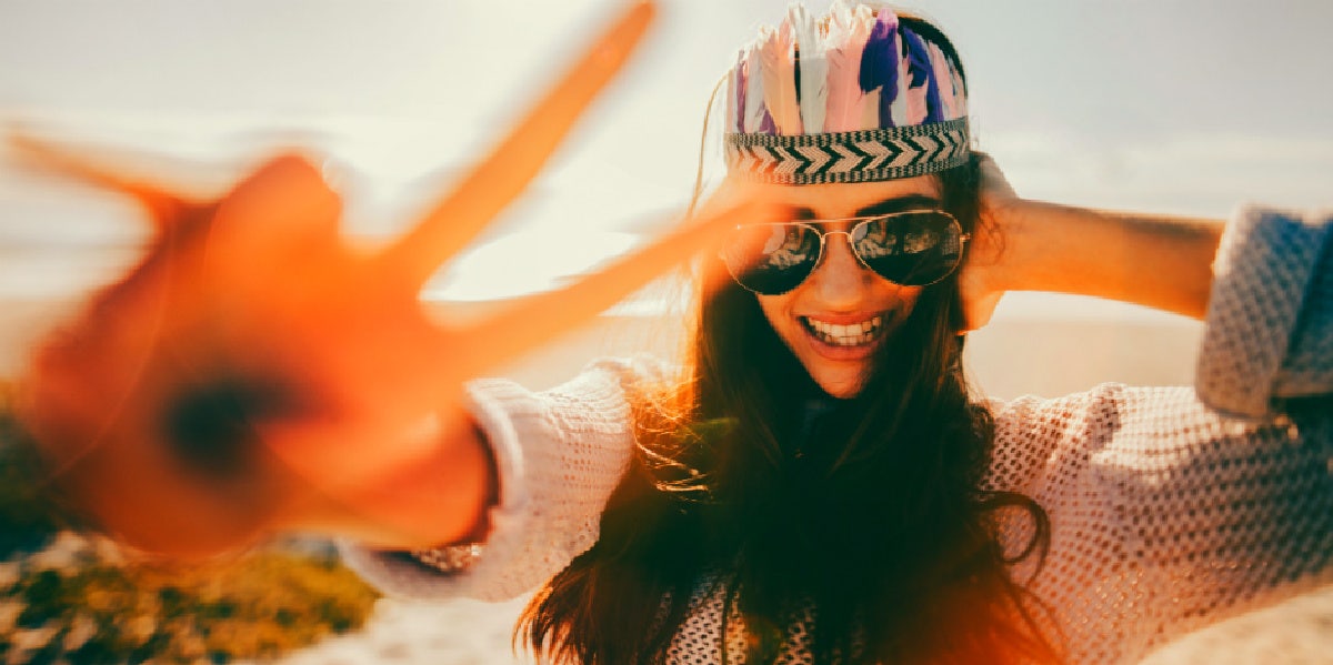 girl smiling and making a peace sign with her fingers