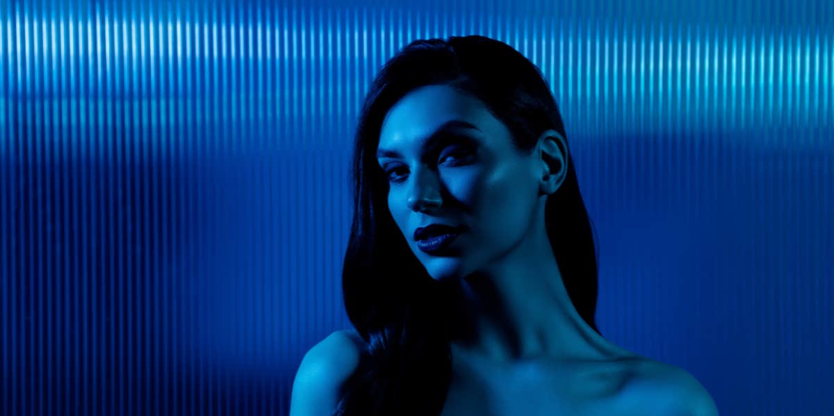 Sneaky Ways Toxic People Manipulate You — And How To Avoid It woman blue background