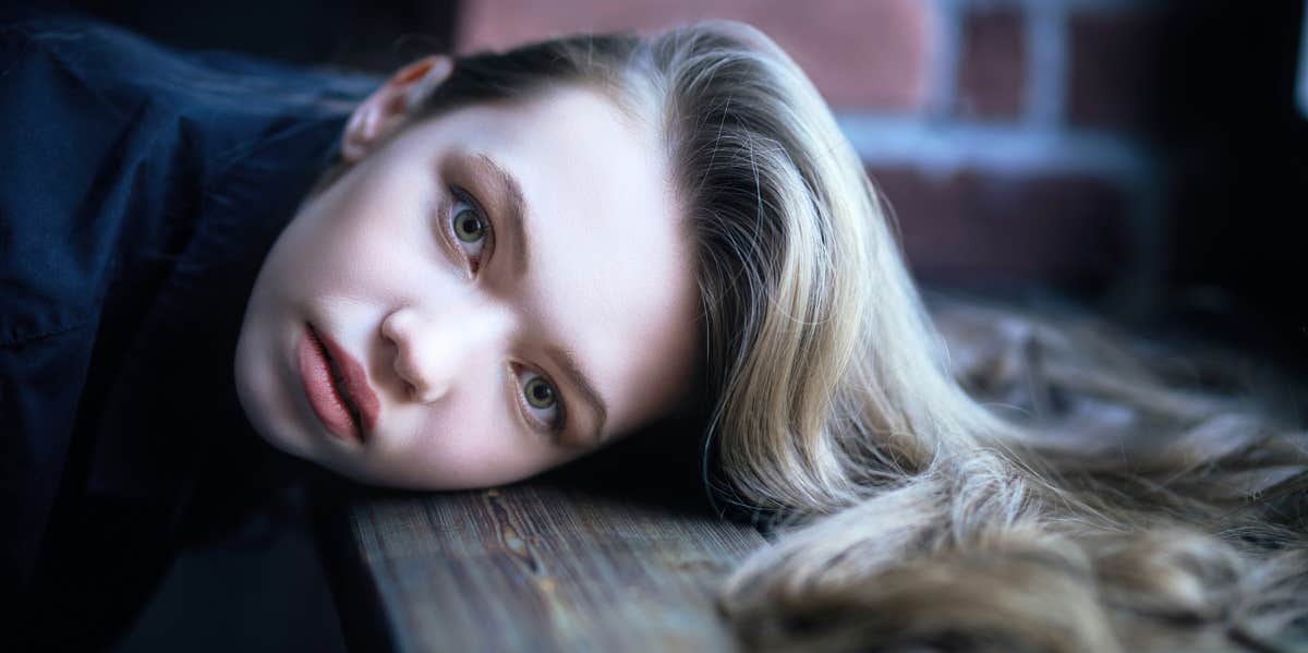 woman resting head on table