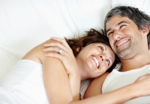 happy couple lying in bed