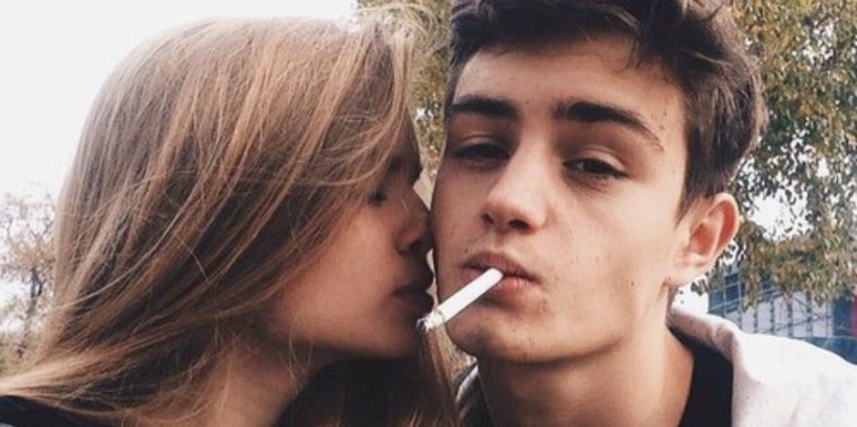 Guy smoking, girl kissing him Guy smoking, girl kissing him
