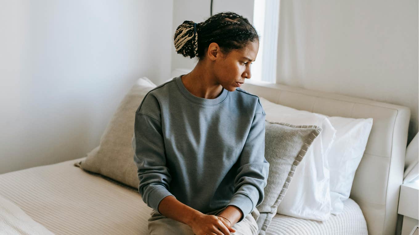 sad woman sitting on bed