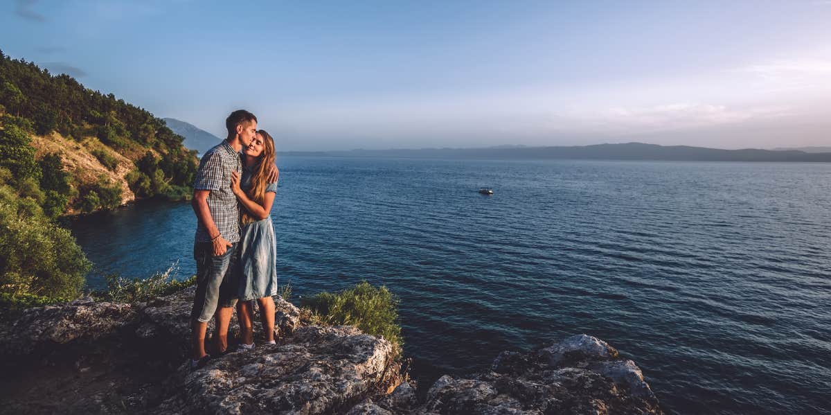 Signs You Should Break Up, Even If Your Relationship Is 'Fine' couple on cliff