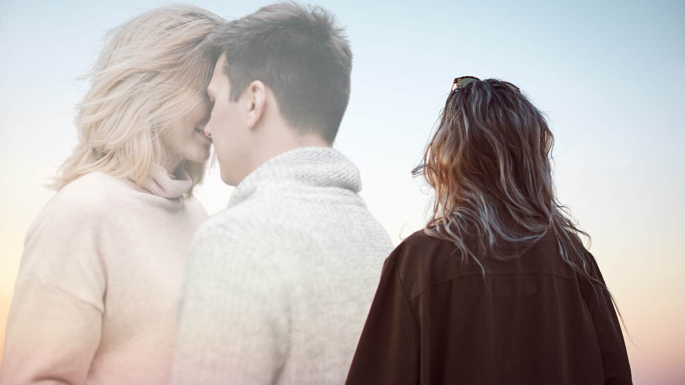 Woman looking up at the sky seeing happy couple 