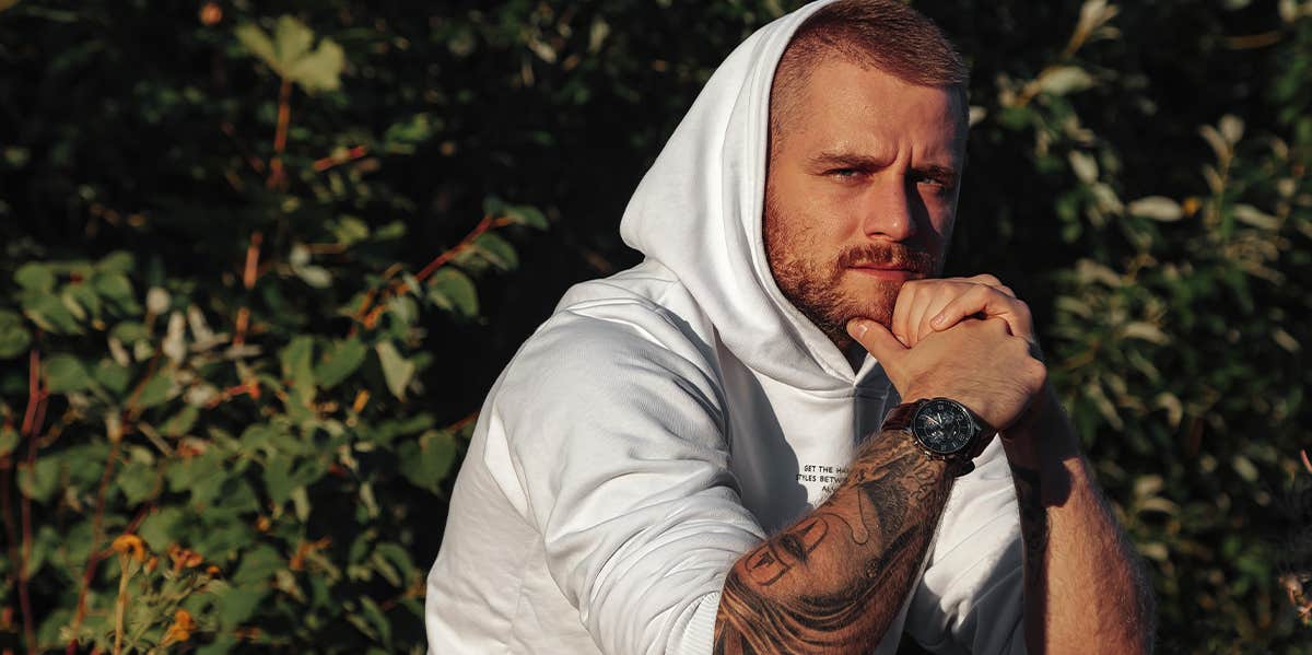 12 Strange Things Men Do That Women Have Zero Idea About guy with tattoos and hood up