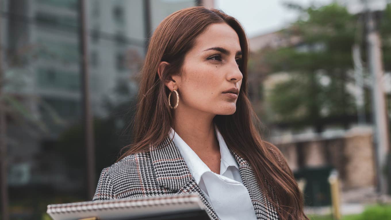 confident woman standing outside building