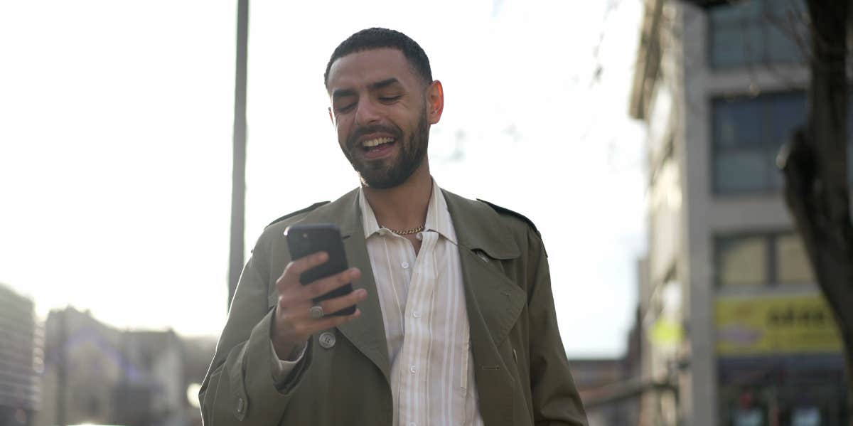 man texting on the street