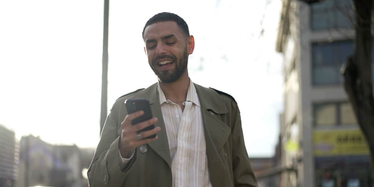 man texting on the street