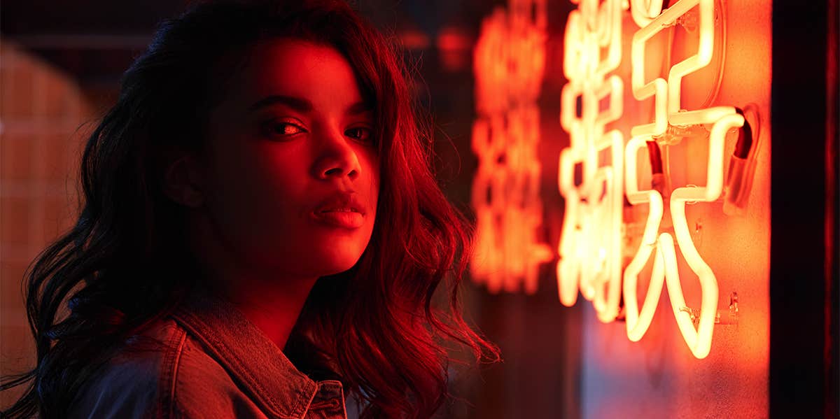 woman standing in neon light