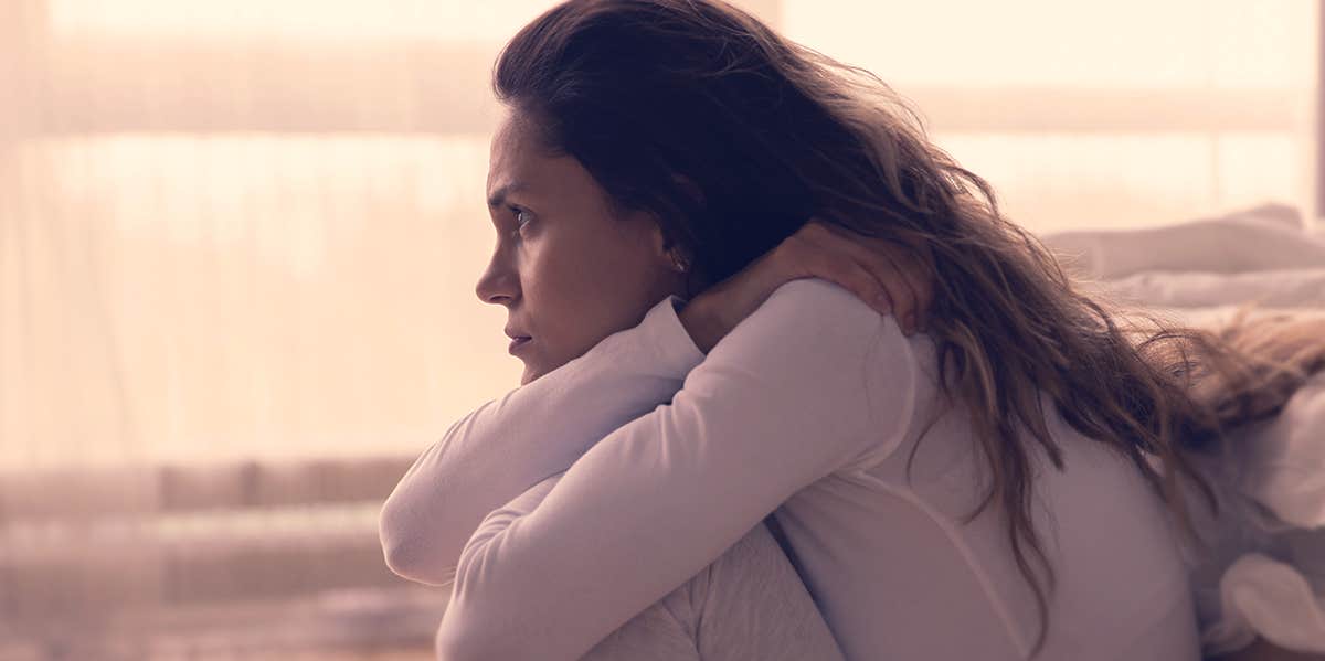 woman staring into the air, looking sad