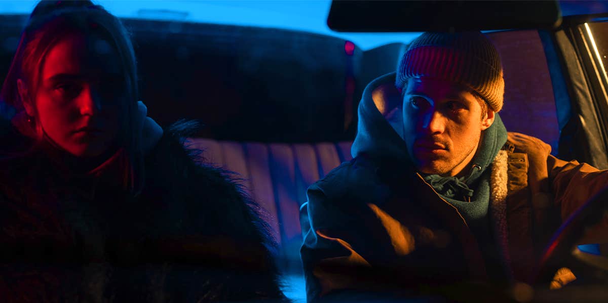 man and woman sitting in dark car